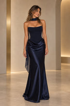 Navy blue satin mermaid evening dress with strapless neckline, draped waist, flowing chiffon scarf and floor-length skirt by Graceprom