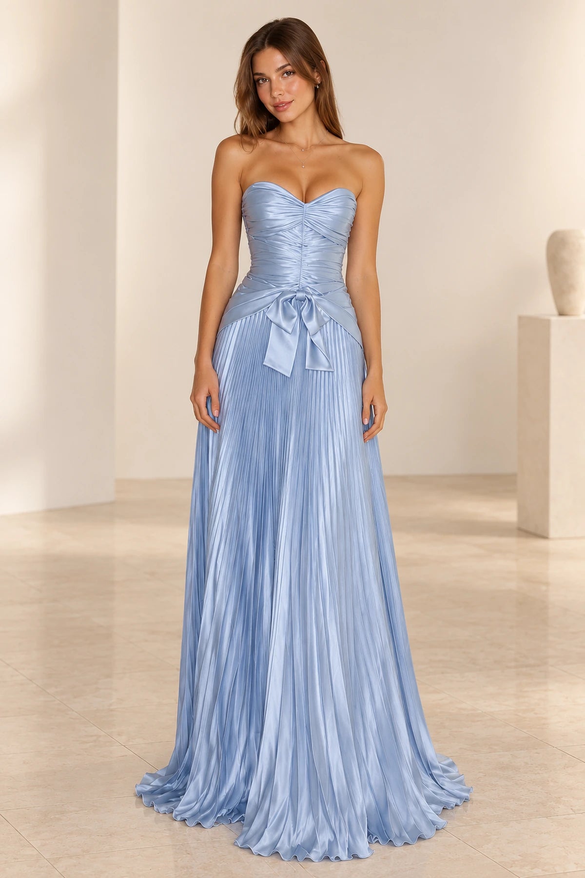 Light blue Graceprom satin wedding guest dress with a strapless sweetheart neckline, ruched bodice, statement bow and floor-length pleated A-line skirt.