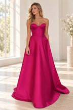 Hot pink satin A-line prom dress with strapless sweetheart neckline, structured corset bodice, fitted waist and flowing floor length skirt by Graceprom