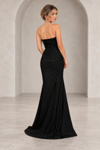 Back view of black sequin chiffon prom dress featuring strapless beaded-look bodice, ruched hips and flowing floor-length mermaid skirt