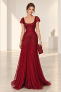 Front view of a burgundy Graceprom sequin mermaid wedding guest dress with a square neckline, sheer flutter sleeves and intricate sparkling patterns.