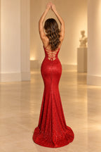 Back view of a red Graceprom sequin evening dress with an open lace-up back, slender crisscross ties, fitted mermaid skirt and sweeping train.