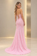 Side and partial back view of a light pink sequin prom gown featuring a lace-up corset back, fitted silhouette, thigh-high slit, and flowing train.