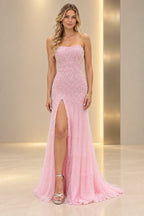 Light pink sequin prom dress with a strapless neckline, fitted sheath silhouette, thigh-high slit, and floor-length hem.