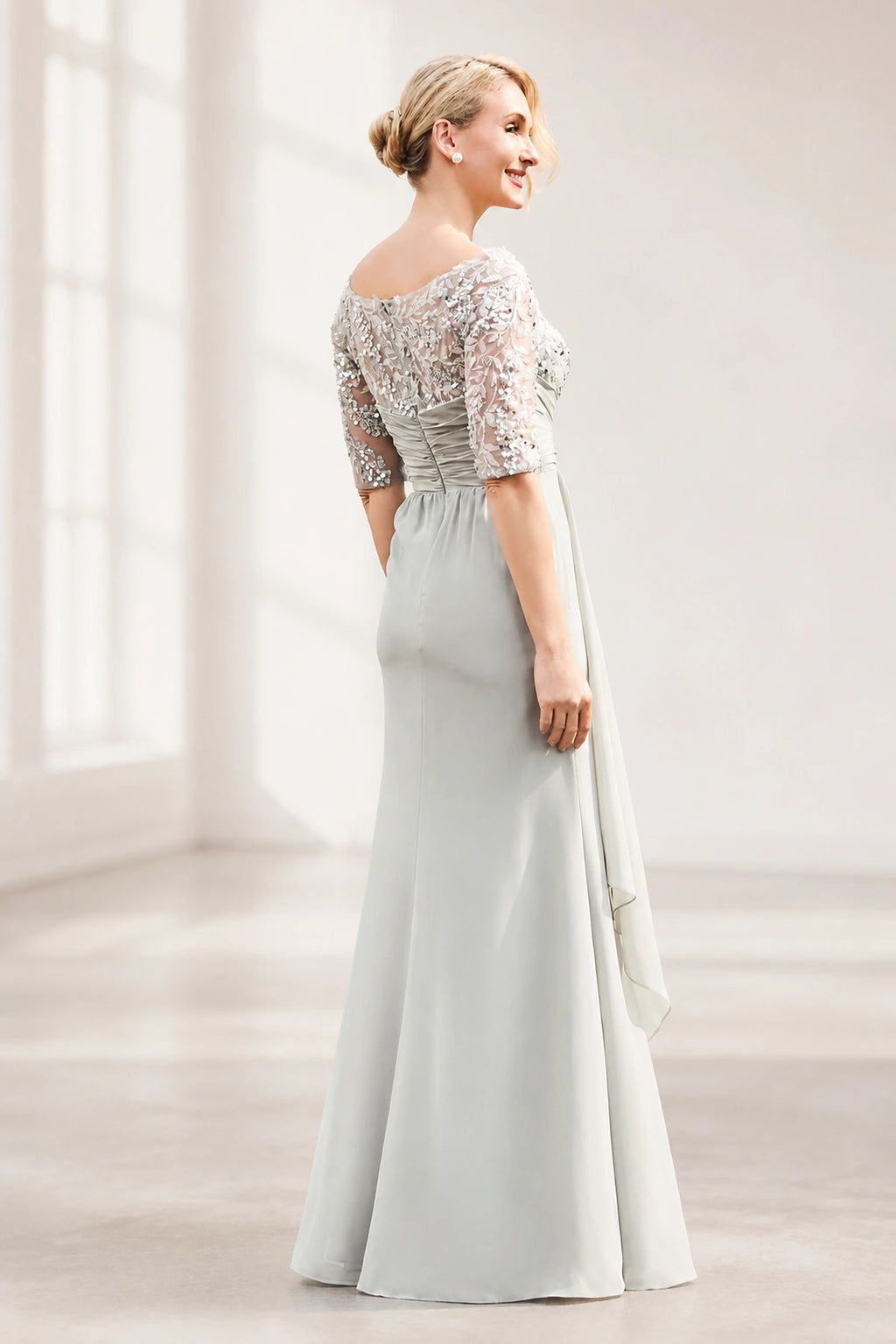 Silver gray mother of the bride dress with floral lace bodice, sheer half sleeves, ruched waist and layered floor-length skirt, front and back view