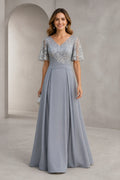 Silver gray A-line mother of the bride dress with V-neckline, lace bodice, flutter sleeves and floor-length skirt