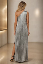 Silver pleated one-shoulder wedding guest dress with open back and floor-length silhouette