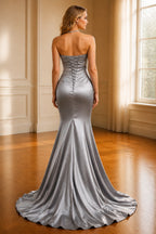 Back view of silver mermaid prom dress with lace-up corset back and sweep train by GraceProm