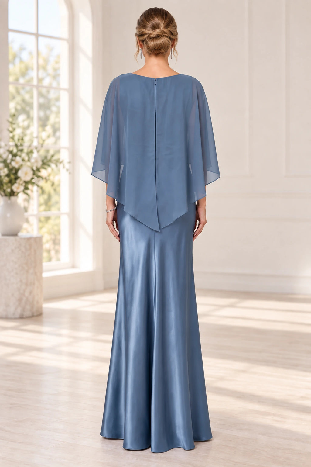 Back view of slate blue mother of the bride dress with cape overlay center zipper and floor-length fitted skirt