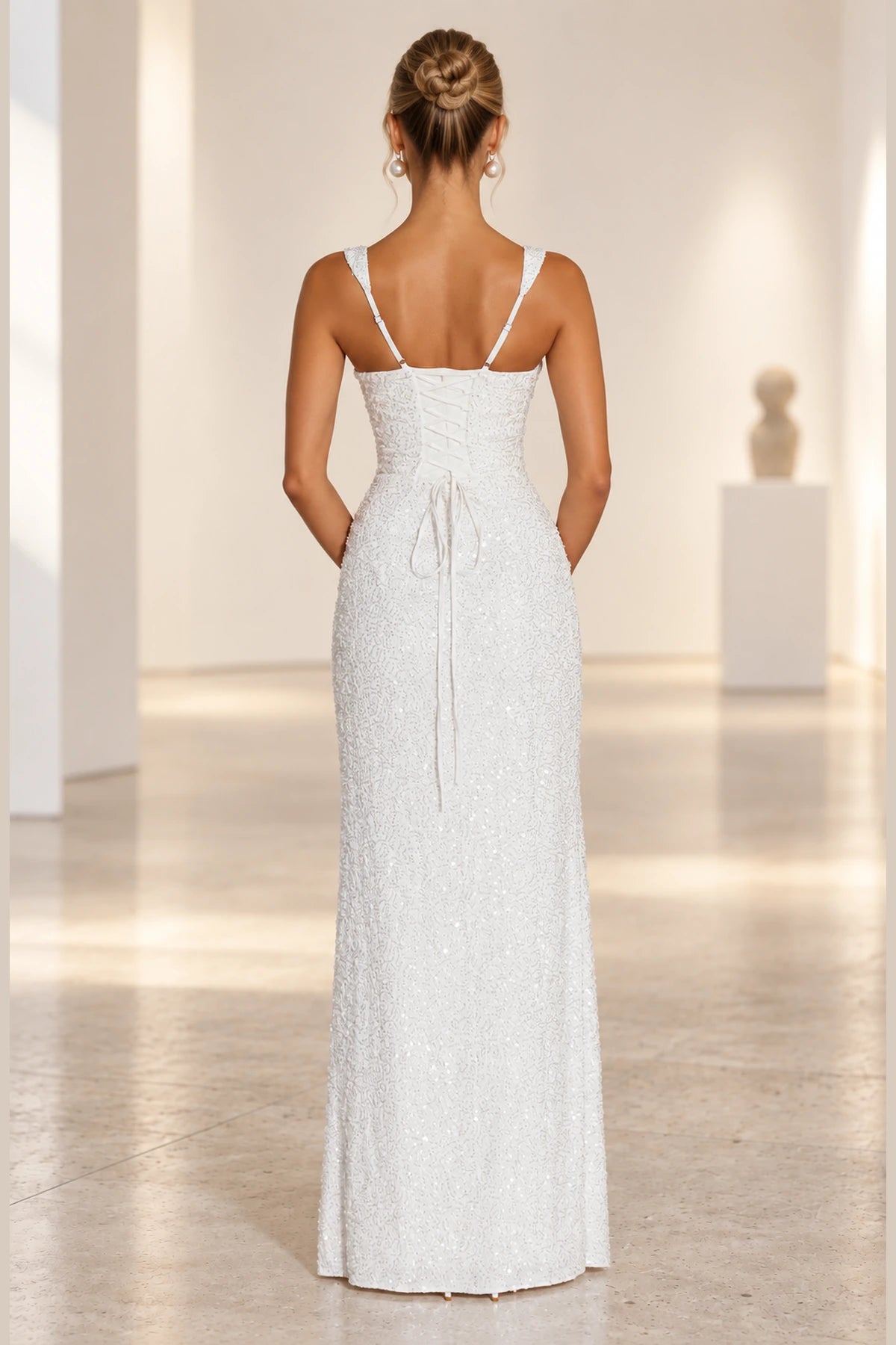 Corset lace up back detail of embellished formal wedding guest gown
