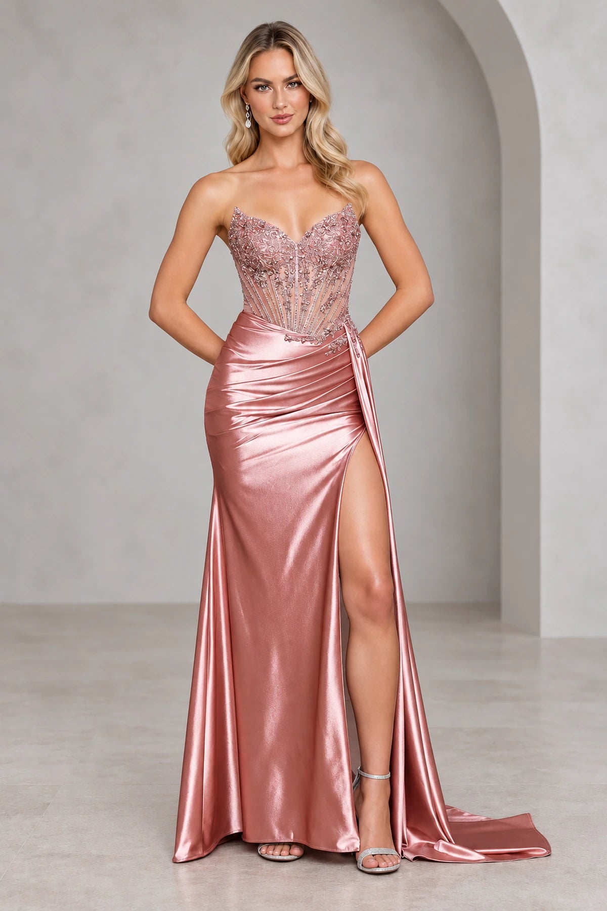 Rose satin prom dress with a strapless sweetheart neckline, beaded illusion corset bodice, ruched hips, thigh-high slit, and long side drape.