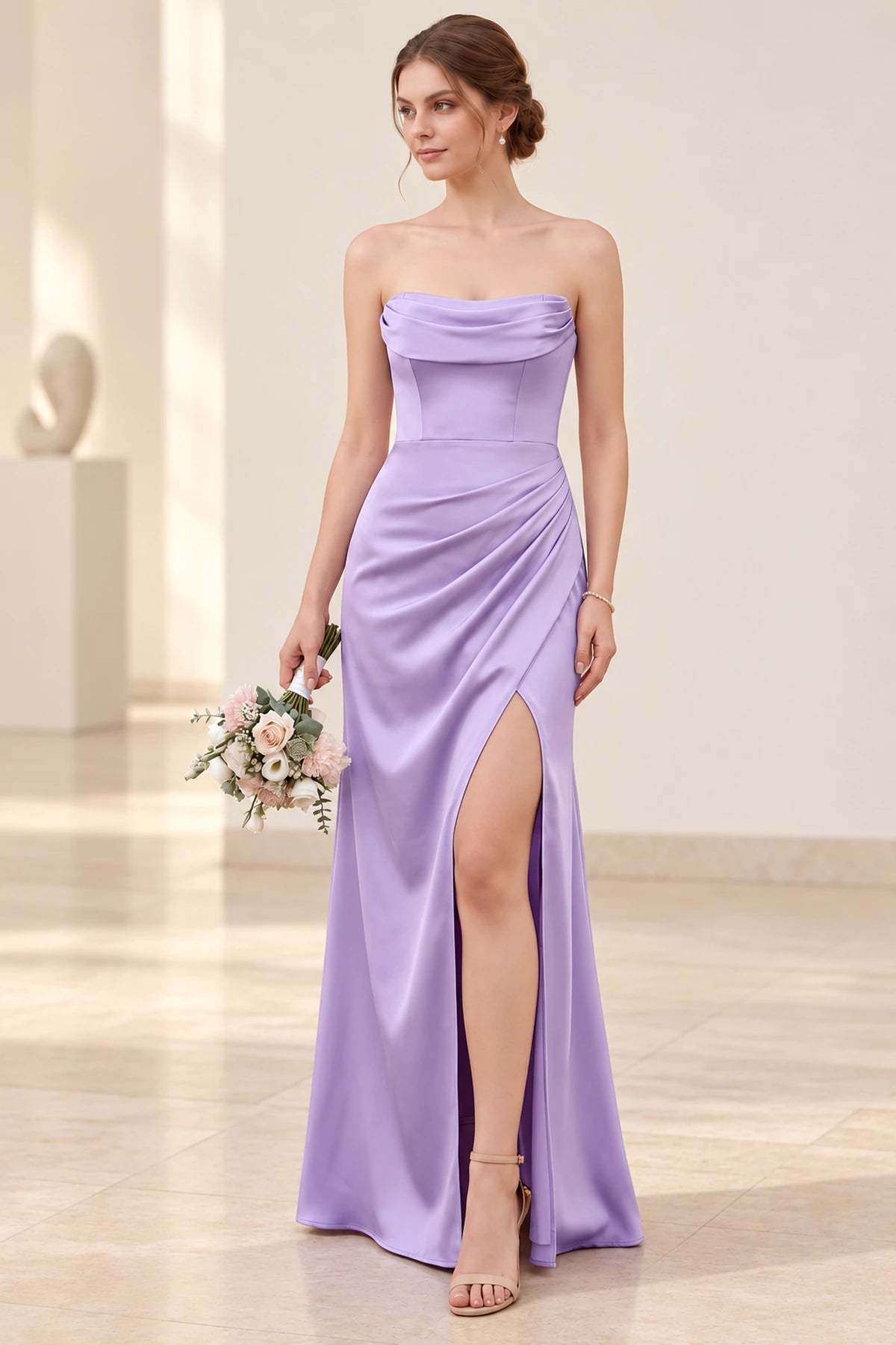 Lilac satin bridesmaid dress with a strapless cowl neckline, fitted bodice, diagonal hip ruching, and thigh-high front slit.