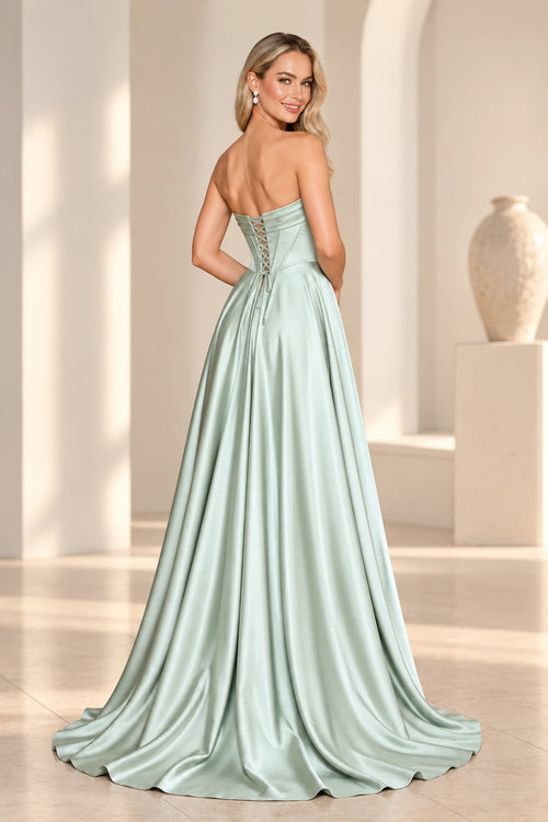 Back view of a sage green satin prom dress with a low lace-up corset back, folded neckline band, flowing A-line skirt, and short train.