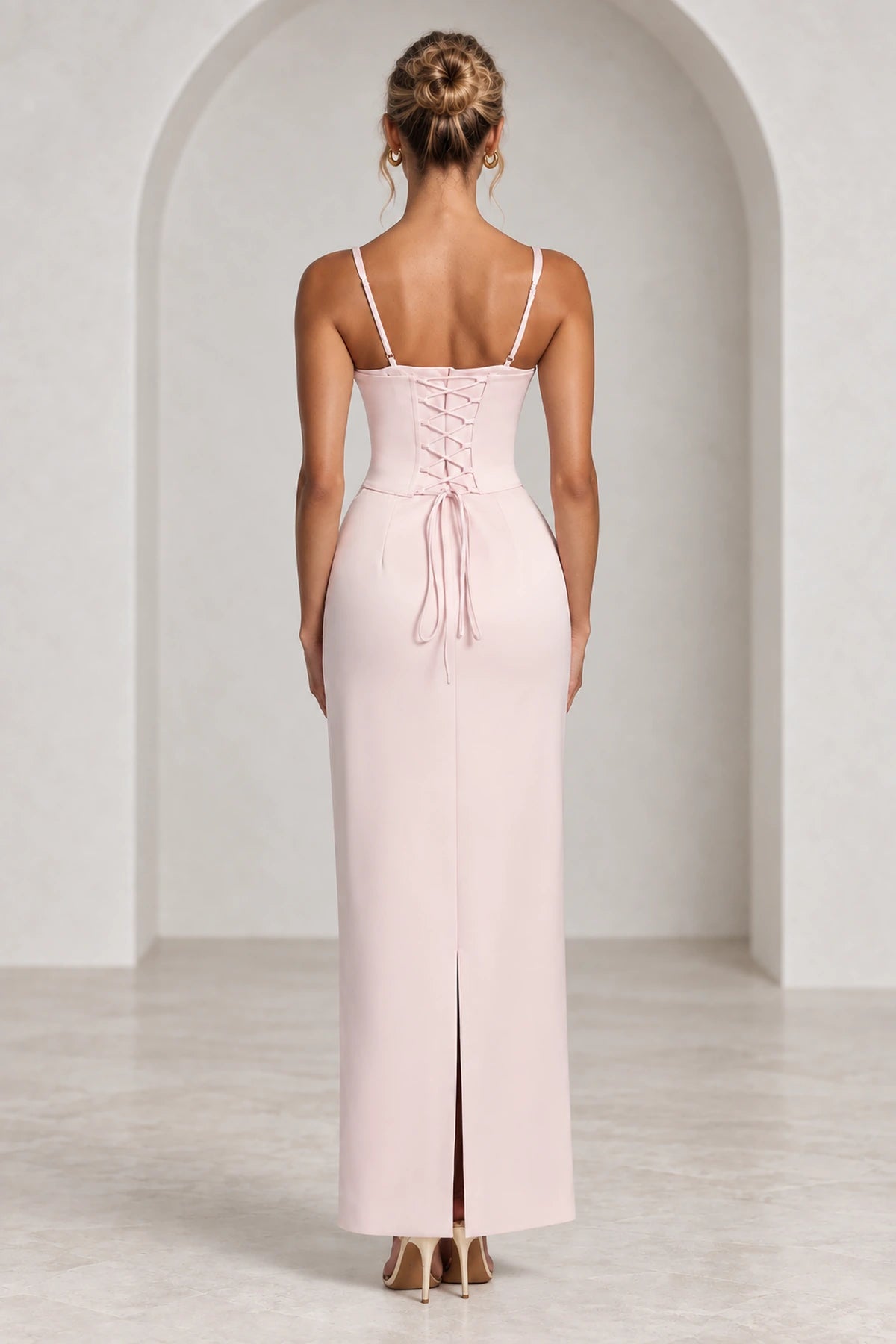 Corset lace up back detail of elegant formal wedding guest gown