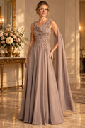 Warm taupe A-line Mother of the Bride Dress with draped cowl neckline, embellished bodice, cape sleeves and floor-length skirt