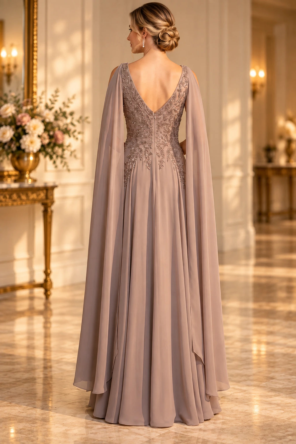Back view of taupe Mother of the Bride Dress with deep V-back, embellished bodice, flowing cape panels and floor-length A-line skirt