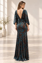 Back view of teal floral mother of the bride dress with deep V low back cape sleeves ruched waist and floor-length skirt