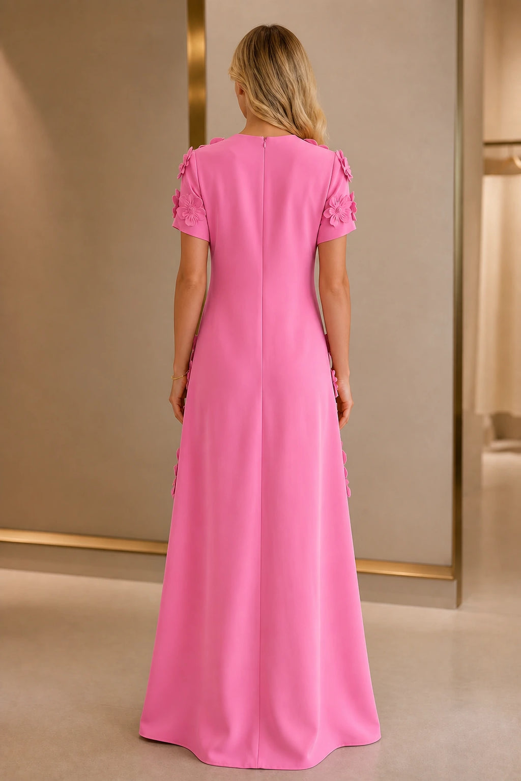 Back view of vibrant pink wedding guest dress with short sleeves, closed zipper back and floor-length A-line silhouette
