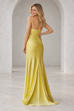 Back view of a yellow strapless mermaid prom dress featuring a fitted bodice, smooth satin-like fabric and a floor-length flared skirt.