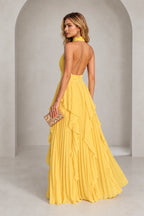Yellow halter neck bridesmaid dress with open back and pleated ruffle skirt